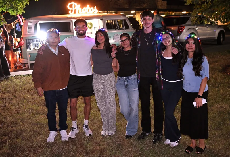 A group of friends posing together at the vintage Volkswagen photo booth, wearing light-up flower crowns.