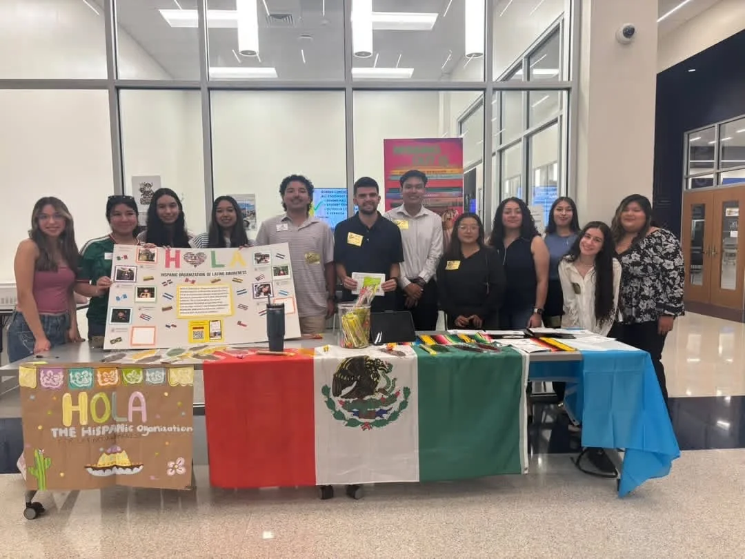 Members of SMC’s LASO and Converse University’s HOLA standing together behind their information tables at Spartanburg High School